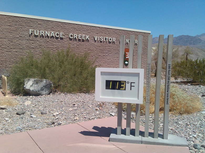 A digital thermostat showing temperature (113F) in Death Valley National Parks' Furnace Creek Visitor Center