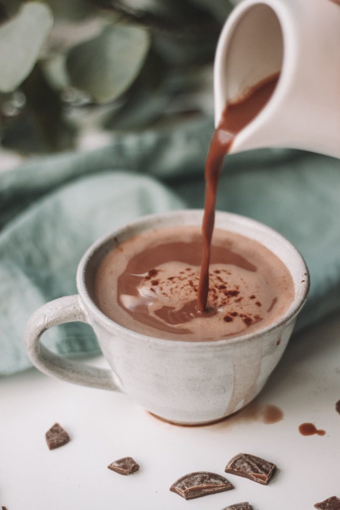 hot chocolate being poured into a mug