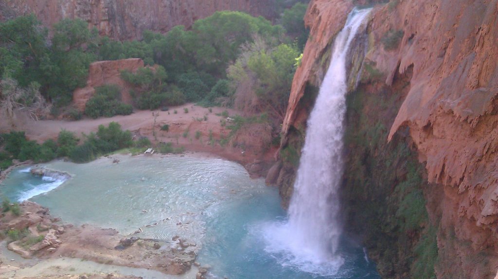 Waterfall into blue pool