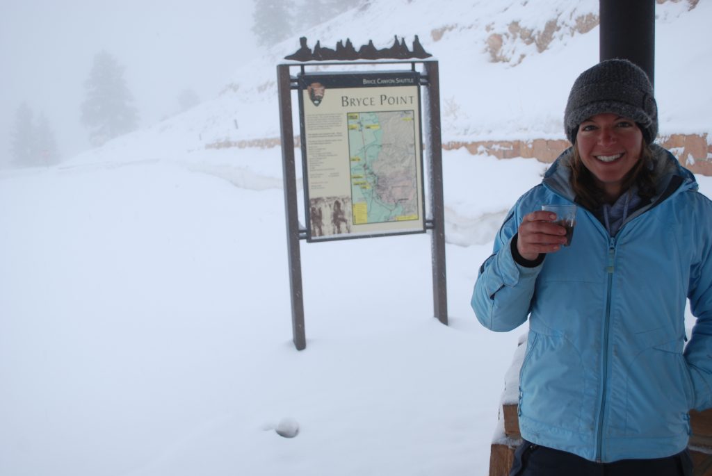 smiling girl in blue winter jacket and wool hat